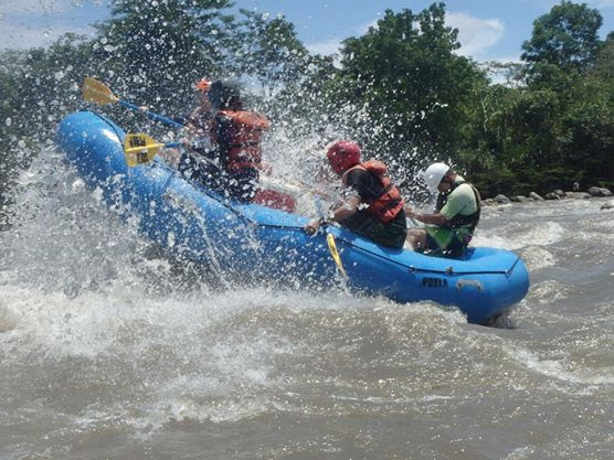 A group of travellers tackle a rapid in their raft on the Amazon river.