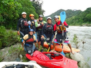 Six experienced local guides by the Amazon river in their safety gear with their kayaks.