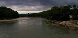 A photo looking along the Amazon river with a dramatic sky.